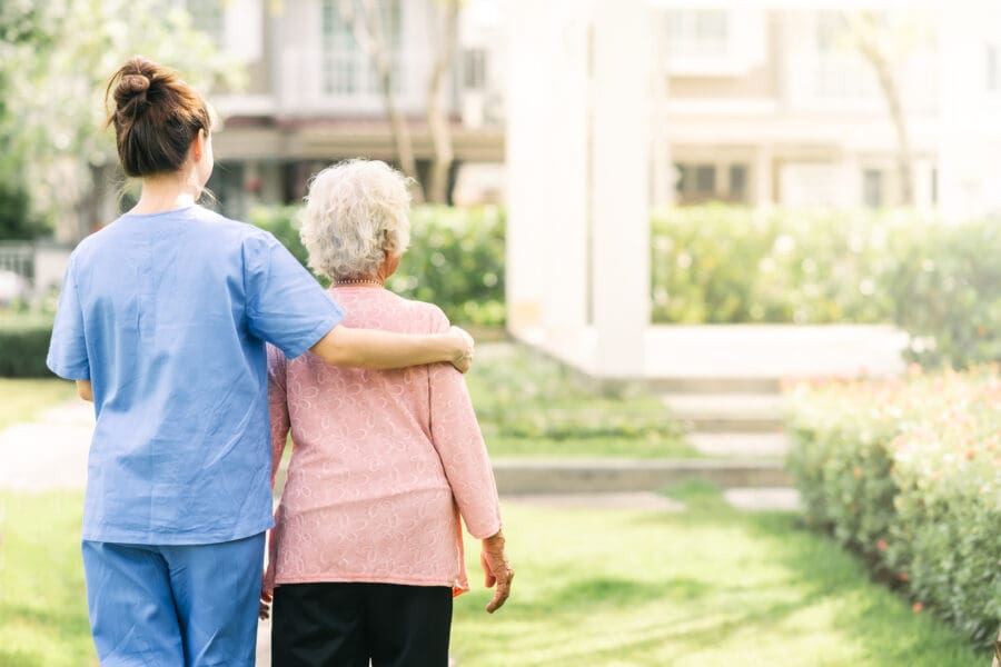 Nurse walking with patient.